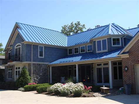 blue house with green metal roof|gray house with blue roof.